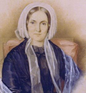 An image of a woman in a white bonnet.