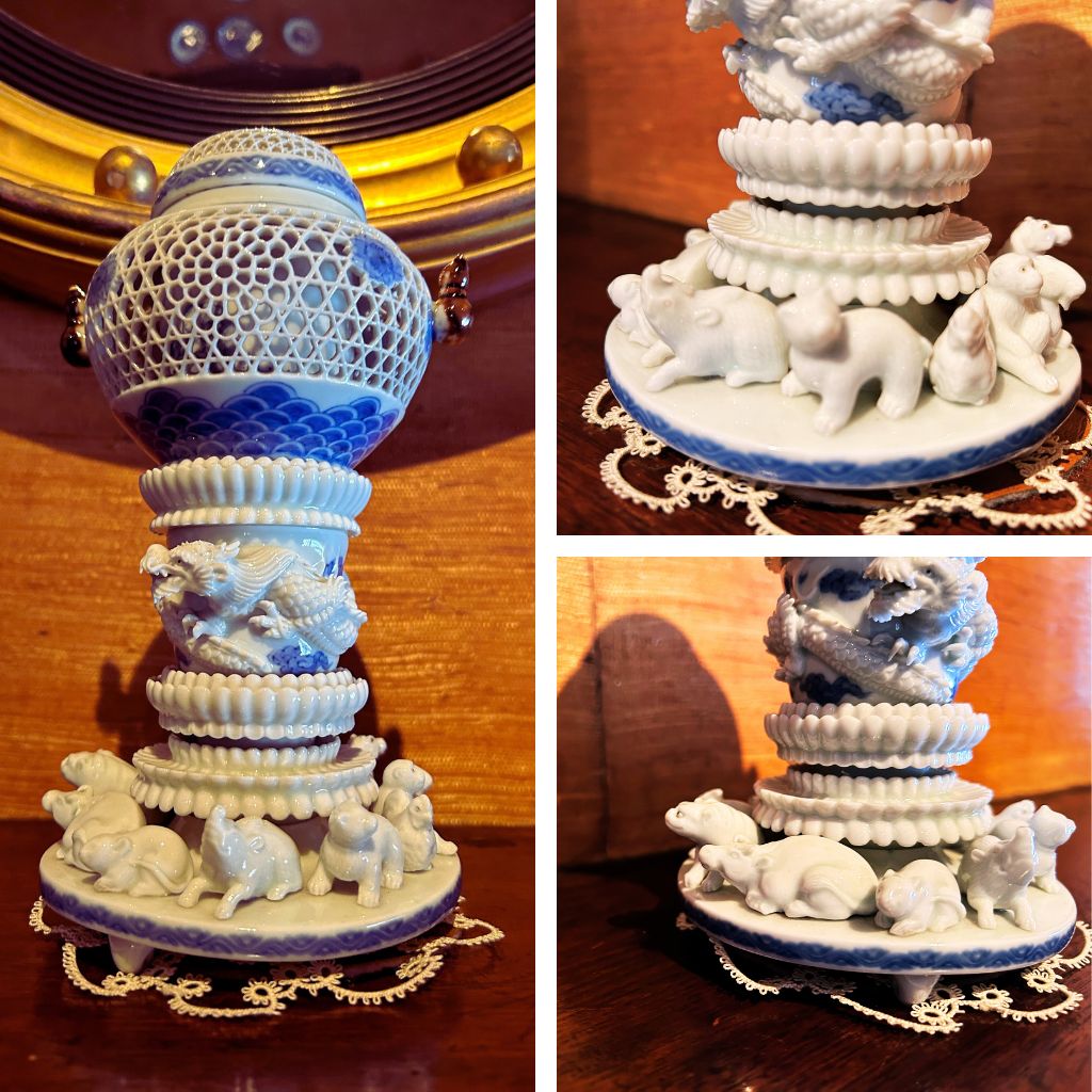 A grid image. On the left there is a full length image of a white and blue porcelain incense burner which has netting made or porcelain in the middle. It sits on a small white doily against a red and gold background. On the right there are two square images that focus on some of the small porcelain animals.