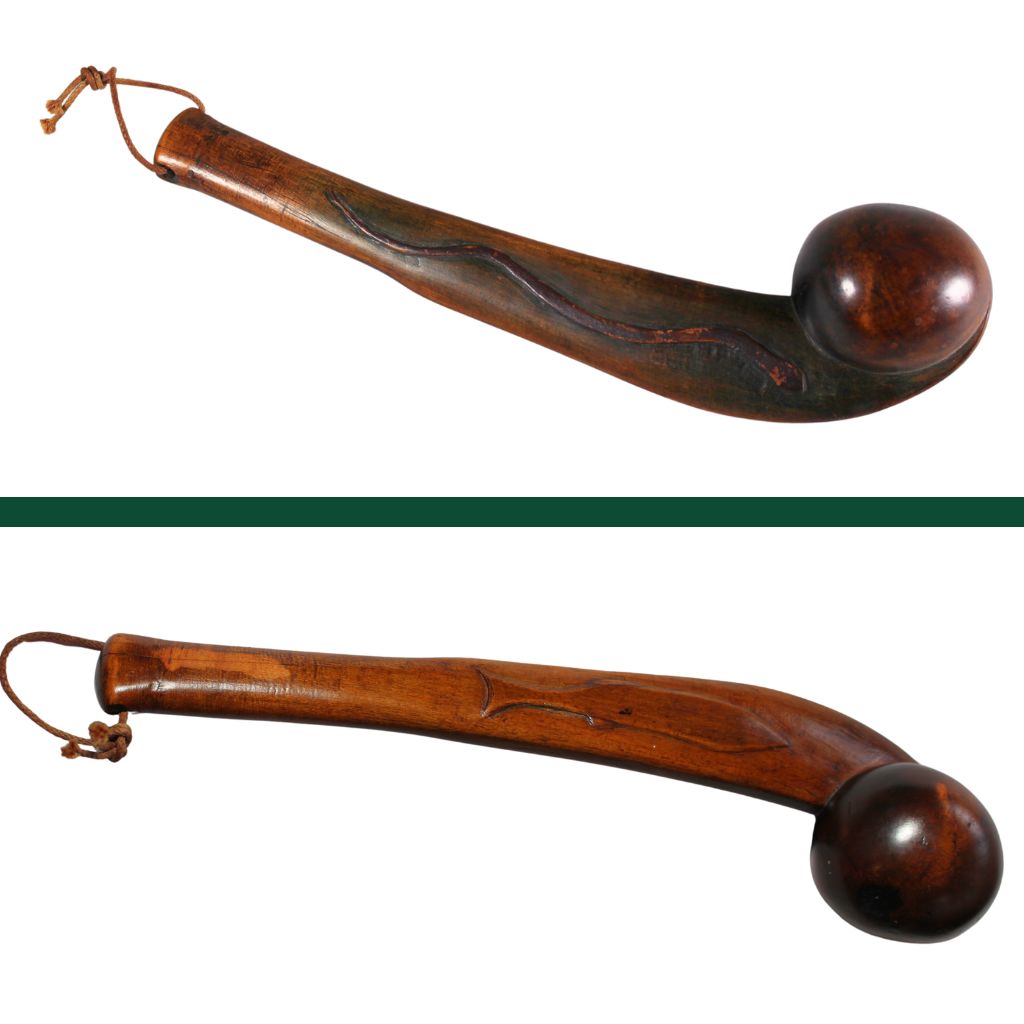 A double image of a club. It is made of wood and curved. On the end it has a thread looped through. On the top image the side of the club has a snake, on the bottom it has a small fish.
