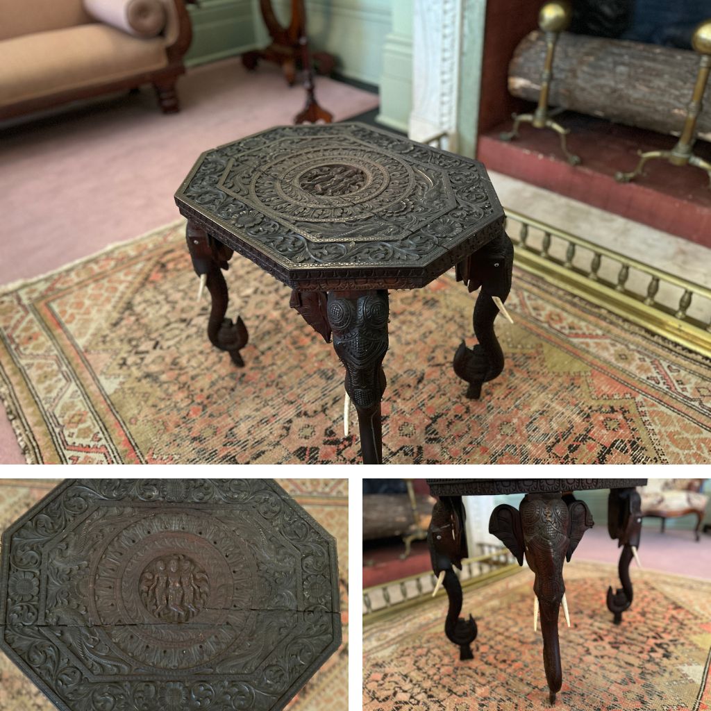 A grid image of an elephant table. At the top there is a table photographed on an angle. It has elephants on the table legs. In the background there is a pink and yellow rug. Below on the left there is an image of the table top which has deities on the center, around it is floral pattern. On the right there is an image of elephant faces with ivory tusks.