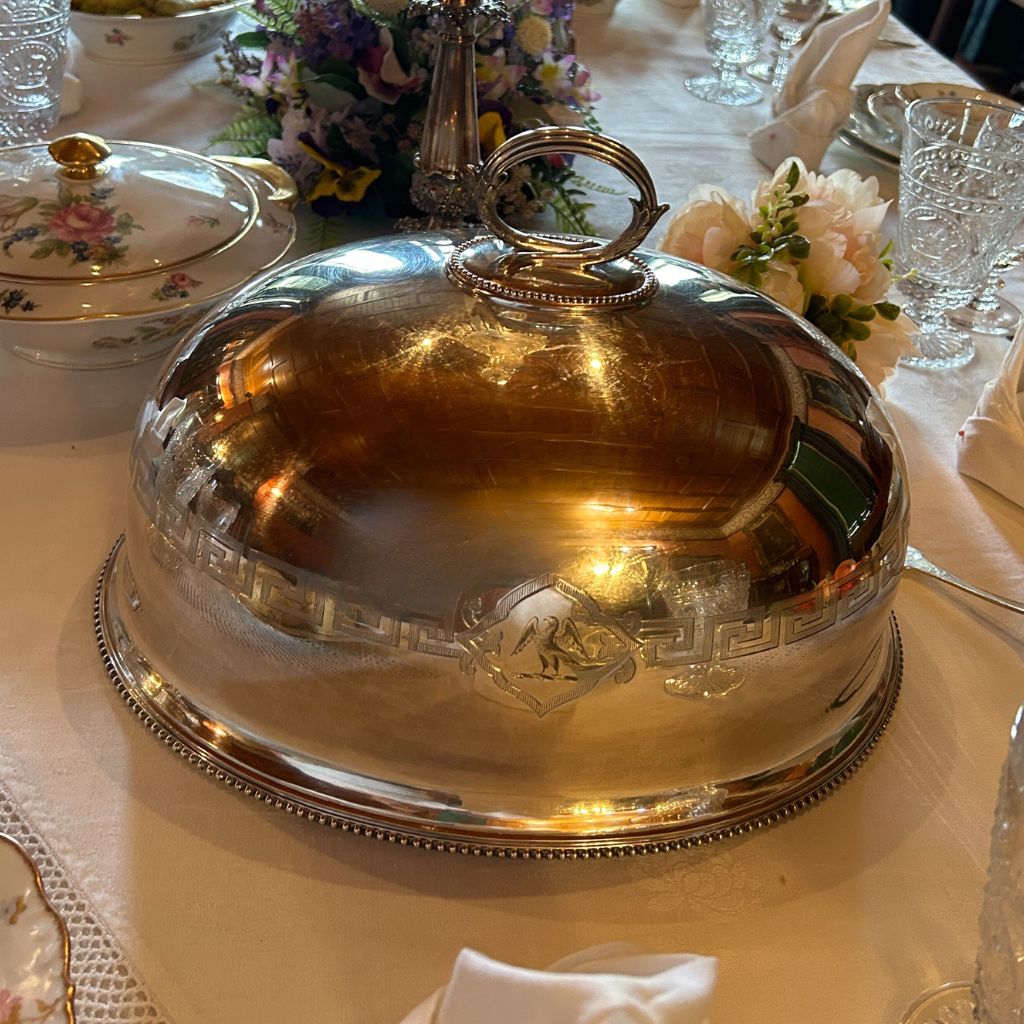 An image of a silver turkey dome. It has a handle on the top.