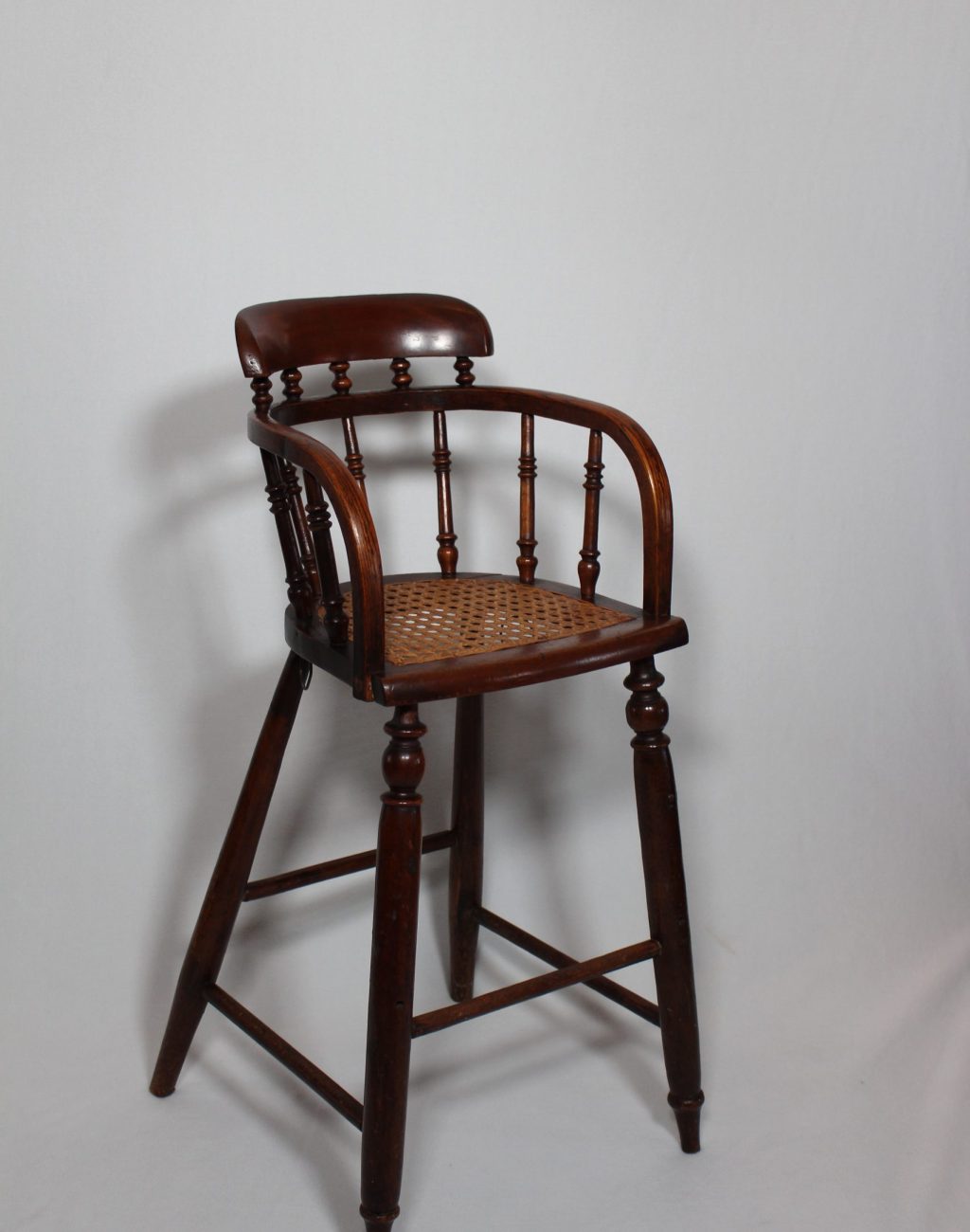 A wooden chair with a wicker seat.